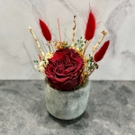 Red preserved rose in a ceramic pot