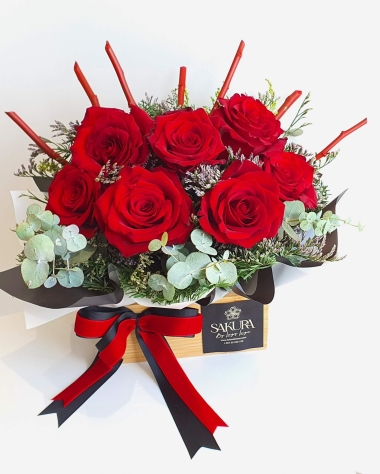 Red roses in a wooden bamboo box