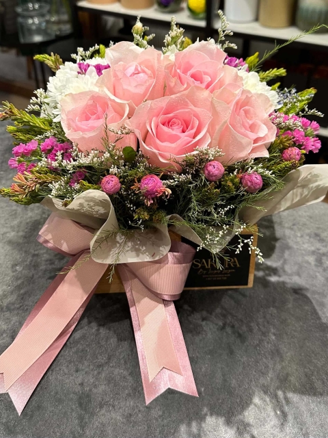 Pink roses in a wooden bamboo box