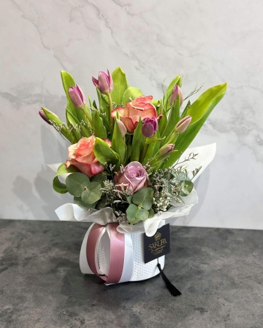 Tulips and roses in a ceramic pot